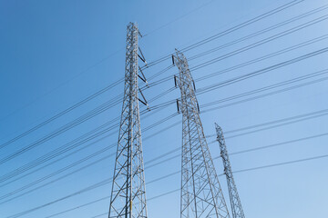 High voltage tower and electic wire on blue sky background.