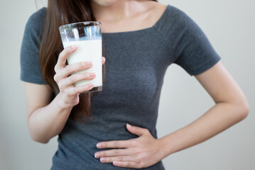 lactose intolerance concept. Woman having a stomachache because drink milk.