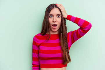 Fototapeta premium Young caucasian woman isolated on green background being shocked, she has remembered important meeting.