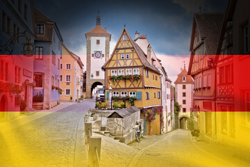 Fototapeta na wymiar Cobbled street and architecture of historic town of Rothenburg ob der Tauber on German flag overlay view