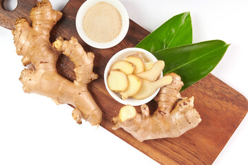 Ginger root and ginger powder in the bowl. Ginger tea and ingredients. Top view. Flat lay. freshly from home growth organic garden. Food concept.