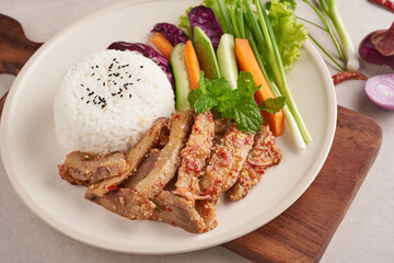 Rice with grilled pork neck. Grilled pork salad thai food with herbs and spices ingredients, tradition northeast food delicious with fresh vegetables, Hot and spicy slice grilled pork menu asian food.