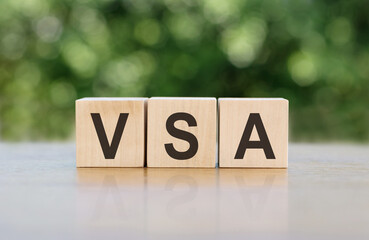 wooden cubes with letters VSA Volume spread analysis on a gray-green background