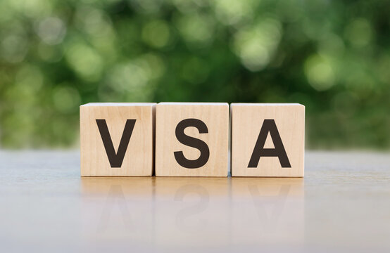 wooden cubes with letters VSA Volume spread analysis on a gray-green background