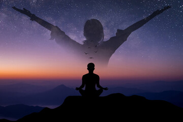 Silhouette of young woman practices yoga and meditates on top of the mountain with double exposure woman standing and open arm and feel free over the sky in beautiful night sky, star and Milky Way.