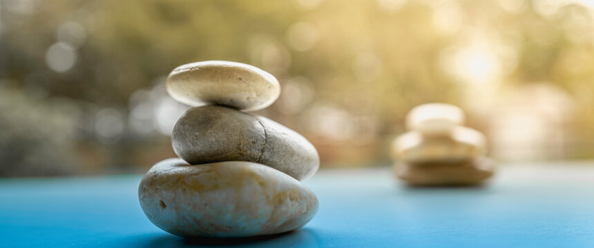 Zen rocks stacked on the blue promenade over the tranquil garden