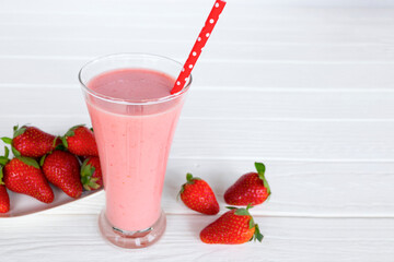 Strawberry yogurt fruit juice smoothie pink colorful fruit juice milkshake blend beverage healthy high protein the taste yummy In glass drink episode morning on white wood background.