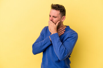 Young caucasian man isolated on yellow background suffers pain in throat due a virus or infection.