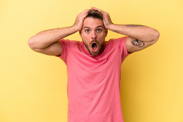 Young caucasian man isolated on yellow background surprised and shocked.