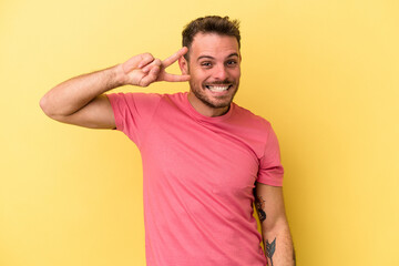 Obraz premium Young caucasian man isolated on yellow background dancing and having fun.