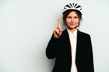 Young business English woman isolated on blue background showing number one with finger.