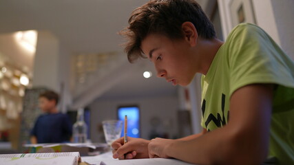 Young boy doing homework after school. Kid preparing for exam