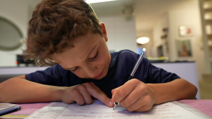Fototapeta na wymiar Young boy doing homework after school. Kid preparing for exam