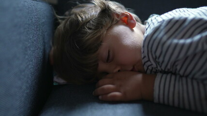 Toddler asleep on sofa. Child napping on couch