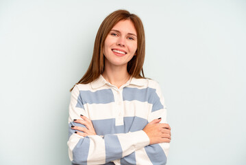 Fototapeta premium Young English woman isolated on blue background who feels confident, crossing arms with determination.