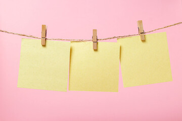Stickers for notes on a pink background. Yellow sticky notes on a string. There is room for copy...