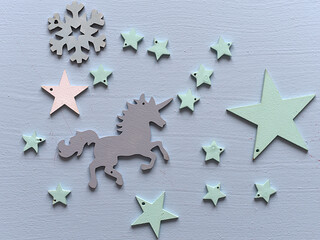 Wooden colorful unicorn horses, card for kids with unicorn and stars trend pastel colors