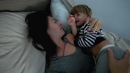 Mother and child in bed in the morning. kid and mom