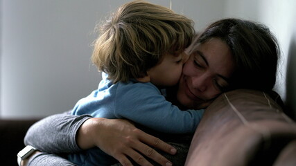 Mother and child authentic love and affection moment, son embracing mom
