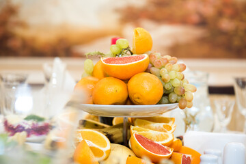 Fruits on the festive table. A table with food served with dishes for guests.