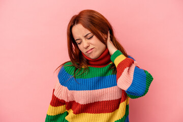 Young caucasian woman isolated on pink background having a neck pain due to stress, massaging and touching it with hand.