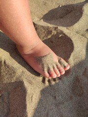 Baby feet on the beach sand