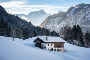 Traditional austrian farmhouse in an idyllic winter landscape, Salzburger Land, Austria