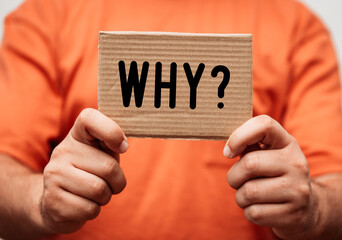hands holding a card board with the word Why? - Business concept