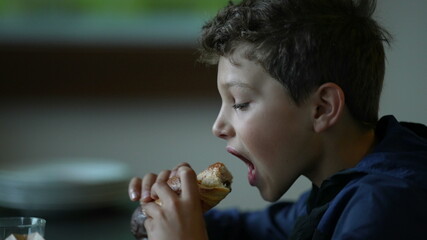 Child eating morning breakfast. Kid eats bread