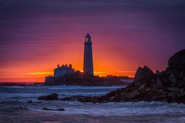 A spectacular sunrise at St Mary's Lighthouse in Whitley Bay, as the sky erupts in color