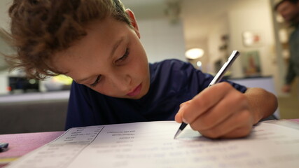Boy doing homework focused in exam preparation