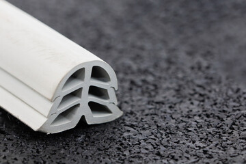 close-up of grey color rubber dilatation on profile, black background
