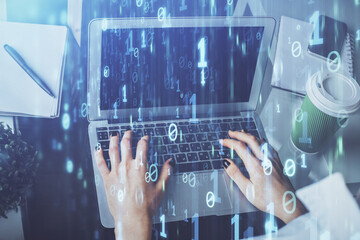 Double exposure of woman hands working on computer and data theme hologram drawing. Tech concept.