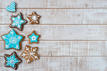 Frame made with different Christmas gingerbread cookies on rustic wooden background, top view. Space for text