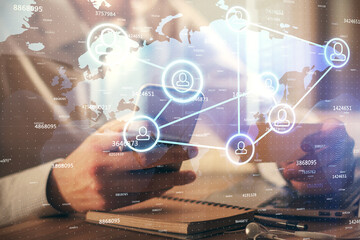 Double exposure of man's hands holding and using a phone and social network theme drawing.