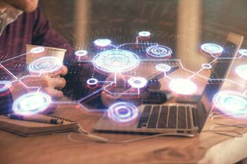 Double exposure of man's hands holding and using a phone and social network theme drawing.