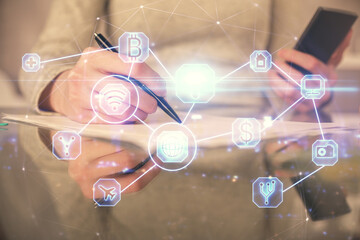 Double exposure of social network sketch hologram and woman holding and using a mobile device.