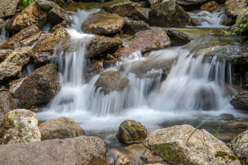 Fototapeta na wymiar waterfall and flowing water in a mountain stream