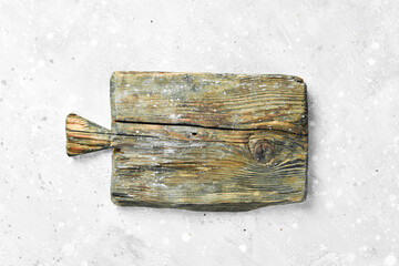 Fototapeta premium Old wooden board on a gray stone background. Kitchen. Top view. Free space for text.
