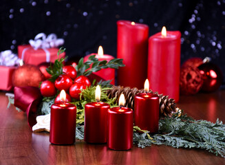 Fototapeta na wymiar Beautiful christmas decoration with burning red candles stock images. Advent burning candles still life stock photo. Christmas candle lights background images