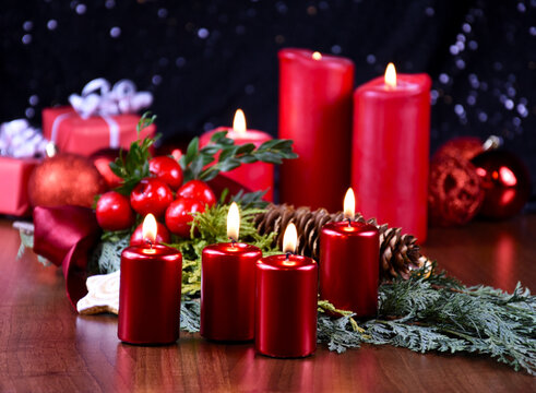 Beautiful christmas decoration with burning red candles stock images. Advent burning candles still life stock photo. Christmas candle lights background images