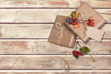 Thanksgiving gift wrapping. Autumn mood. Dry leaves herbarium nature kraft paper as decoration.