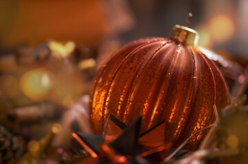Close up of copper colored Christmas ball. Handmade crackled glass ball. In the background a lot of...