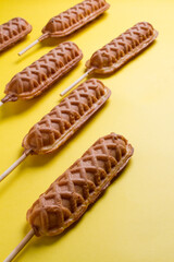 waffles sticks plains on yellow background. making patterns