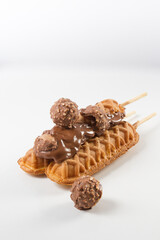 waffles sticks (three) with chocolate glazed and chocolate cookies. white background
