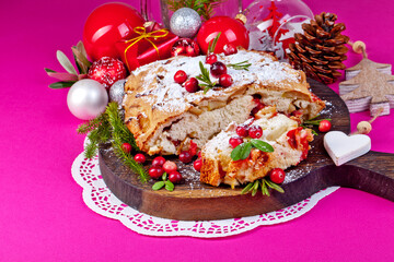 Delicious cranberry pie with fresh cranberries and herbs for Christmas on on a crimson background