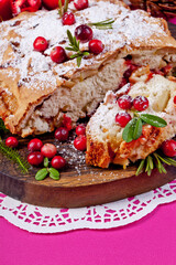 Delicious cranberry pie with fresh cranberries and herbs for Christmas on on a crimson background