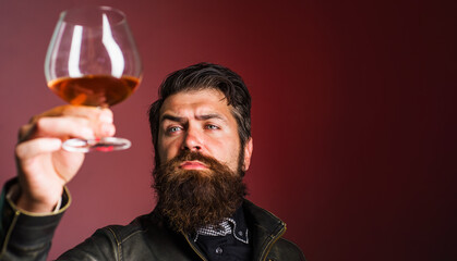 Strong alcohol. Bearded man with glass of whiskey. Degustation and tasting. Selective focus. Copy space.