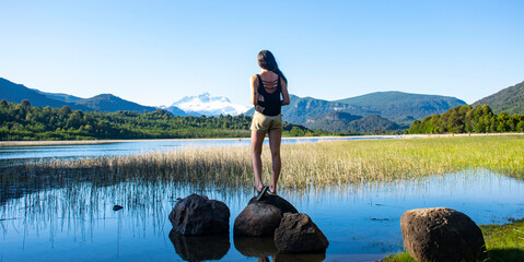 young woman stand up on rock, landscape