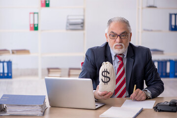 Old male employee in remuneration concept at workplace